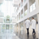 employees walking in a healthcare building with sound and communication systems