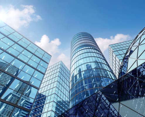 Modern style hi rise blue glass building exterior with sunny blue sky background 3d render for future business headquarter digital smart city concept