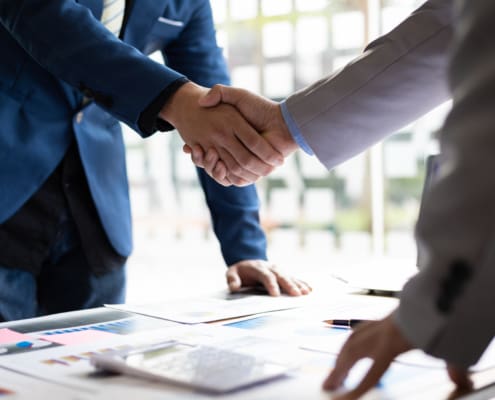 Business partner handshake after the meeting. Financial and investment cooperation.
