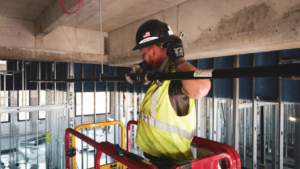 Fire sprinkler installation technician working on a commercial sprinkler piping system in an Orange County building project.